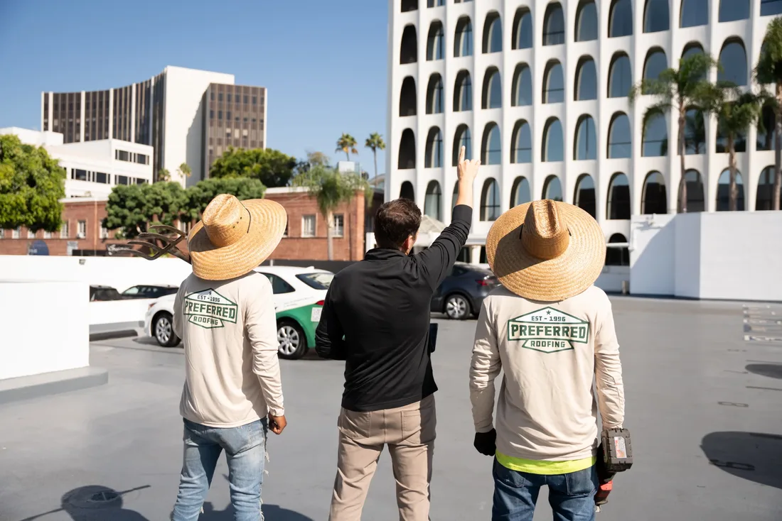 The Preferred Roofing crew surveying a commercial building in Los Angeles